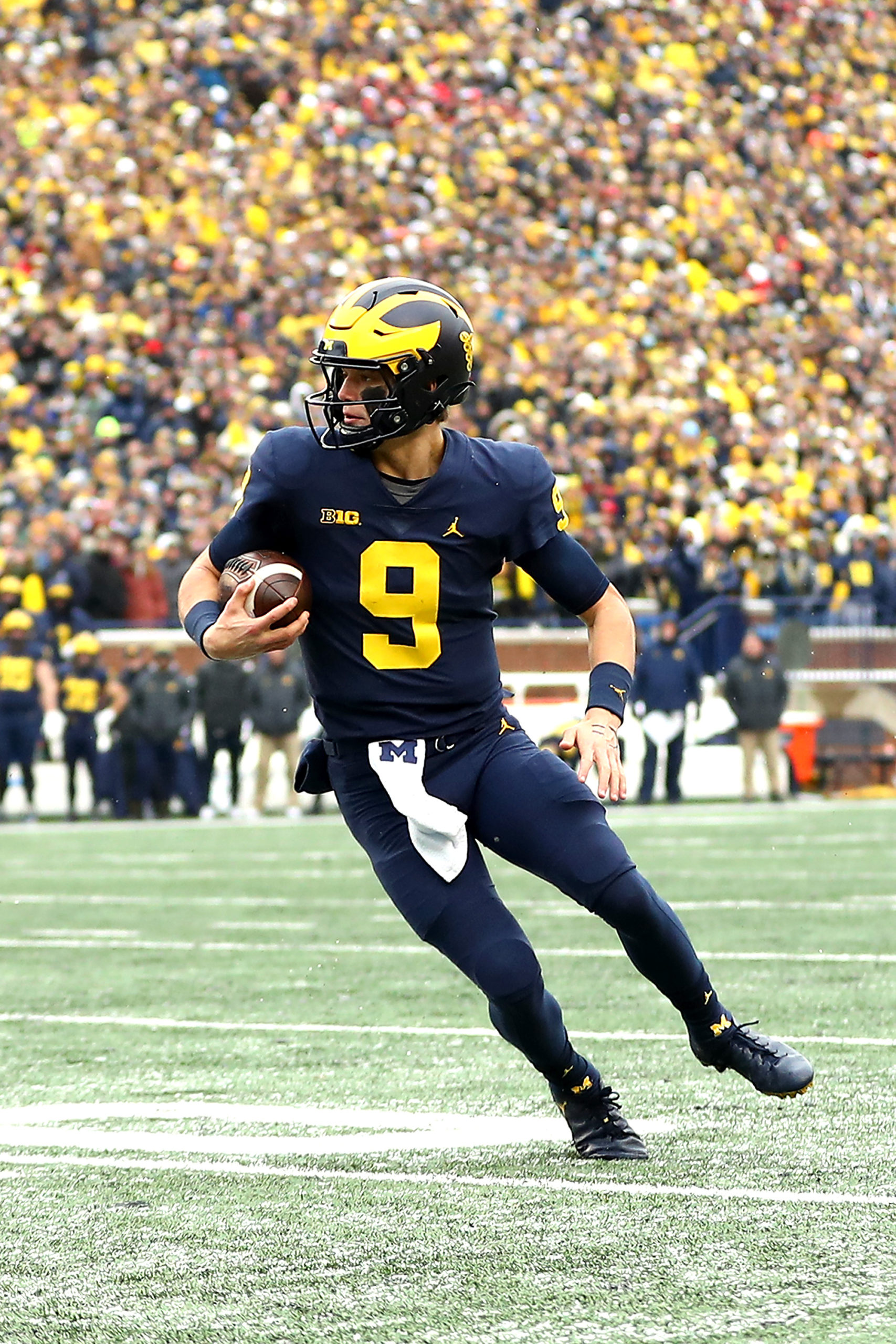 ANN ARBOR, MICHIGAN - NOVEMBER 27: J.J. McCarthy #9 of the Michigan Wolverines carries the ball against the Ohio State Buckeyes in the third quarter of the game at Michigan Stadium on November 27, 2021 in Ann Arbor, Michigan. (Photo by Mike Mulholland/Getty Images)