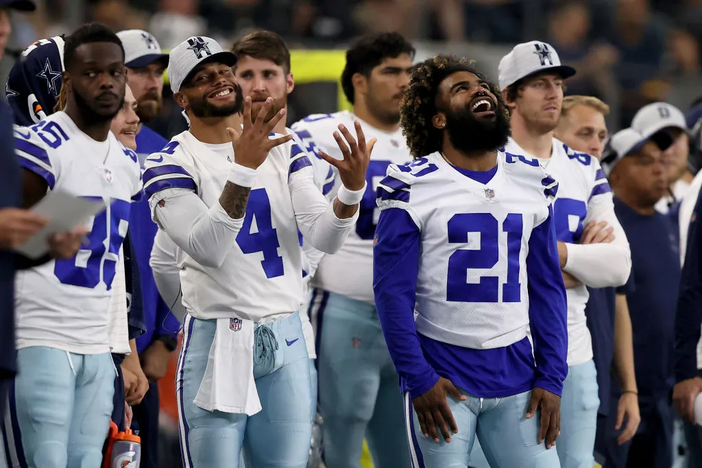 ARLINGTON, TEXAS - AUGUST 29: Quarterback Dak Prescott #4 of the Dallas Cowboys and running back Ezekiel Elliott #21 of the Dallas Cowboys looks on as the Dallas Cowboys take on the Jacksonville Jaguars during the second quarter of a NFL preseason football game at AT&T Stadium on August 29, 2021 in Arlington, Texas. (Photo by Tom Pennington/Getty Images)