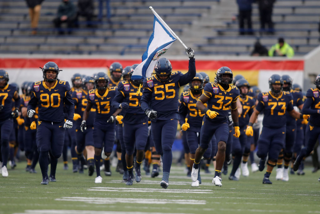 MEMPHIS, TN - DECEMBER 31: West Virginia Mountaineers defensive lineman Dante Stills (55) leads his team on to the field prior to kickoff of the AutoZone Liberty Bowl between the West Virginia Mountaineers and the Army black Knights on December 31, 2020 at Liberty Bowl Memorial Stadium in Memphis, Tennessee.(Photo by Charles Mitchell/Icon Sportswire via Getty Images)