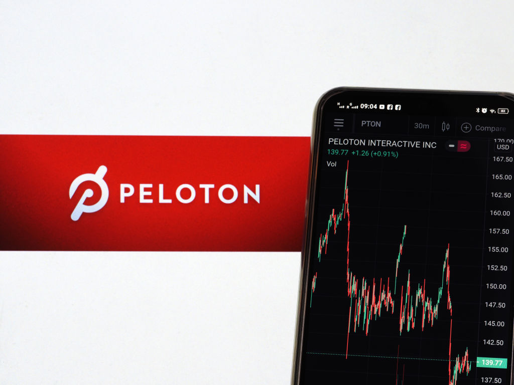 UKRAINE - 2021/02/21: In this photo illustration the stock market graphic of Peloton Interactive, Inc seen displayed on a smartphone with a logo of Peloton Interactive, Inc in the background. (Photo Illustration by Igor Golovniov/SOPA Images/LightRocket via Getty Images)