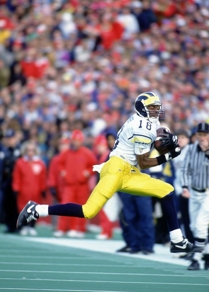 30 Oct 1993: Wide receiver Amani Toomer of the University of Michigan makes a leaping catch in bounds during the Wolverines 13-10 loss to the University of Wisconsin at Camp Randall Stadium in Madison, Wisconsin.