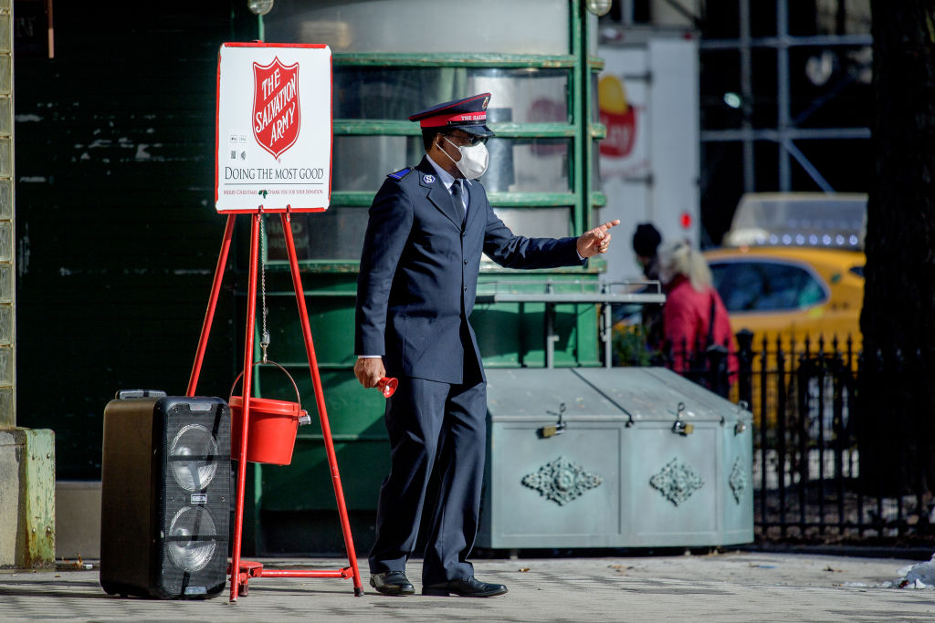 NEW YORK, NEW YORK - DECEMBER 23: A Salvation Army Bell Ringer collects donations for the holiday at the Upper West Side in Manhattan during the coronavirus (COVID-19) pandemic on December 23, 2020 in New York City. The pandemic has caused long-term repercussions throughout the tourism and entertainment industries, including temporary and permanent closures of historic and iconic venues, costing the city and businesses billions in revenue. (Photo by Roy Rochlin/Getty Images)