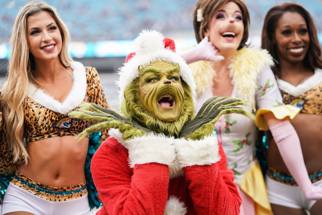 JACKSONVILLE, FLORIDA - DECEMBER 08: The Grinch poses with cheerleaders from the Jacksonville Jaguars before the start of a game against the Los Angeles Chargers at TIAA Bank Field on December 08, 2019 in Jacksonville, Florida. (Photo by James Gilbert/Getty Images)