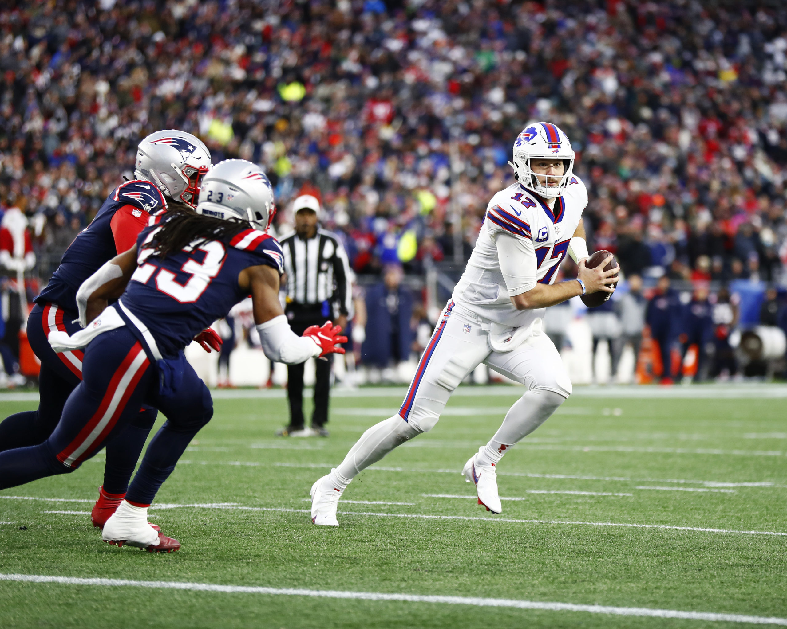 FOXBOROUGH, MASSACHUSETTS - DECEMBER 26: Quarterback Josh Allen #17 of the Buffalo Bills rolls out to his left during the fourth quarter of the game against the New England Patriots at Gillette Stadium on December 26, 2021 in Foxborough, Massachusetts. (Photo by Omar Rawlings/Getty Images)