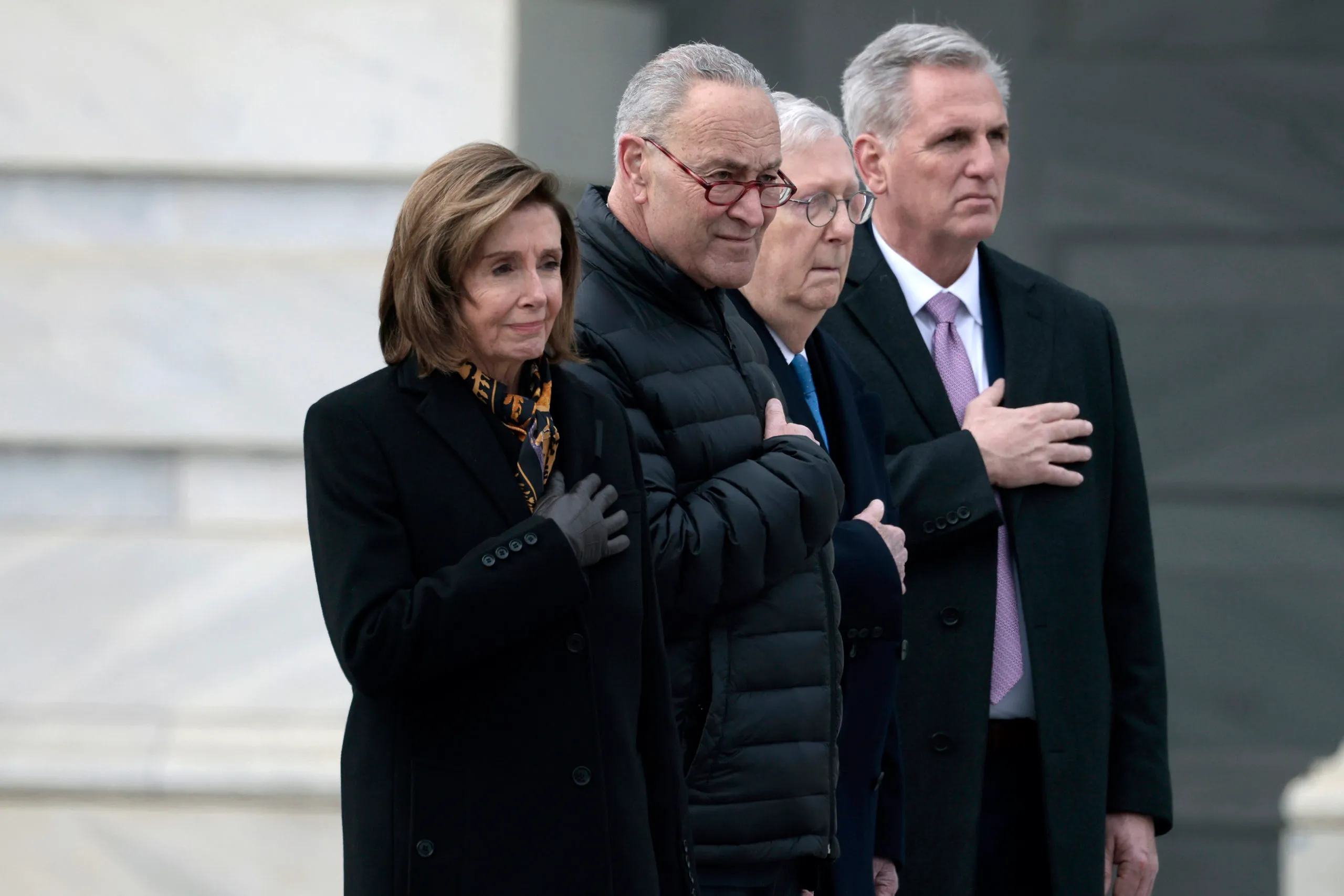 WASHINGTON, DC - DECEMBER 10: Speaker of the House Nancy Pelosi (D-CA), Majority Leader Charles Schumer (D-NY), Minority Leader Mitch McConnell (R-KY) and House Minority Leader Kevin McCarthy (R-CA) watch as joint services military honor guard carries the casket of the late Sen. Robert Dole (R-KS) down the steps of the U.S. Capitol after lying in state on December 10, 2021 in Washington, DC. Dole, a veteran who was severely injured in World War II, was a Republican Senator from Kansas from 1969 to 1996. He ran for president three times and became the Republican nominee for president in 1996. (Photo by Anna Moneymaker/Getty Images)