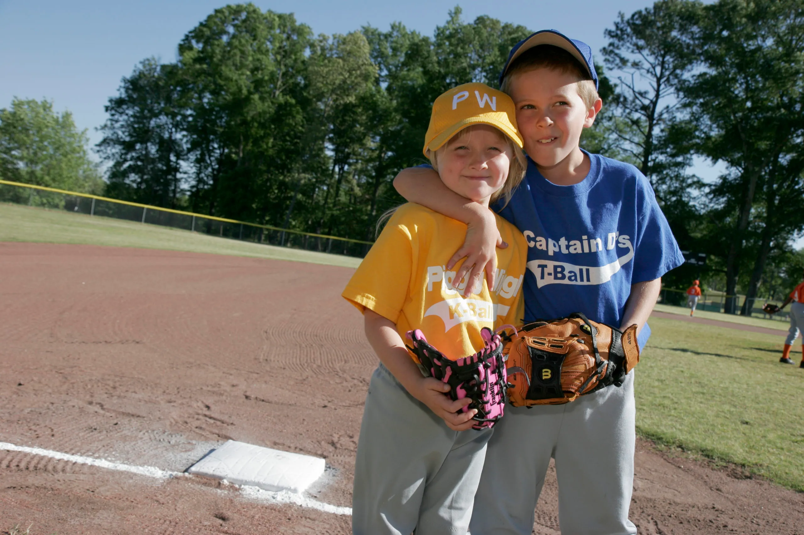 A sister and brother hugging on the pitch at the little league baseball at Veterans Park in Monroeville. (Photo by: Jeffrey Greenberg/Universal Images Group via Getty Images)