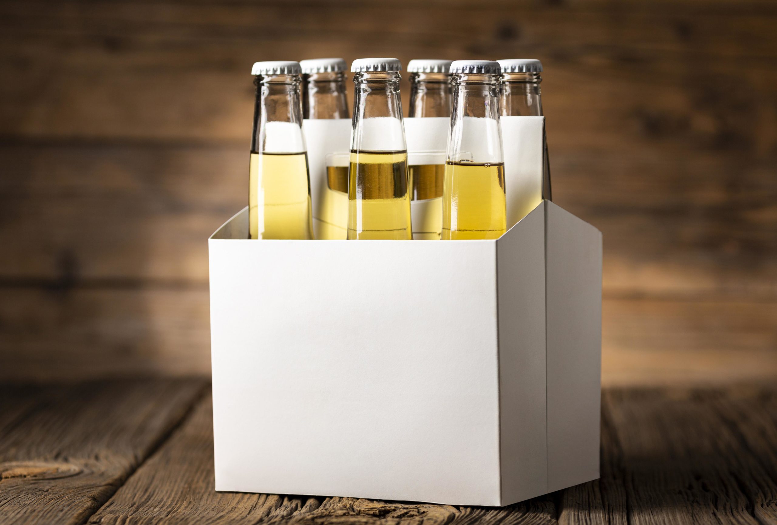 Close-up of beer bottles in box on table