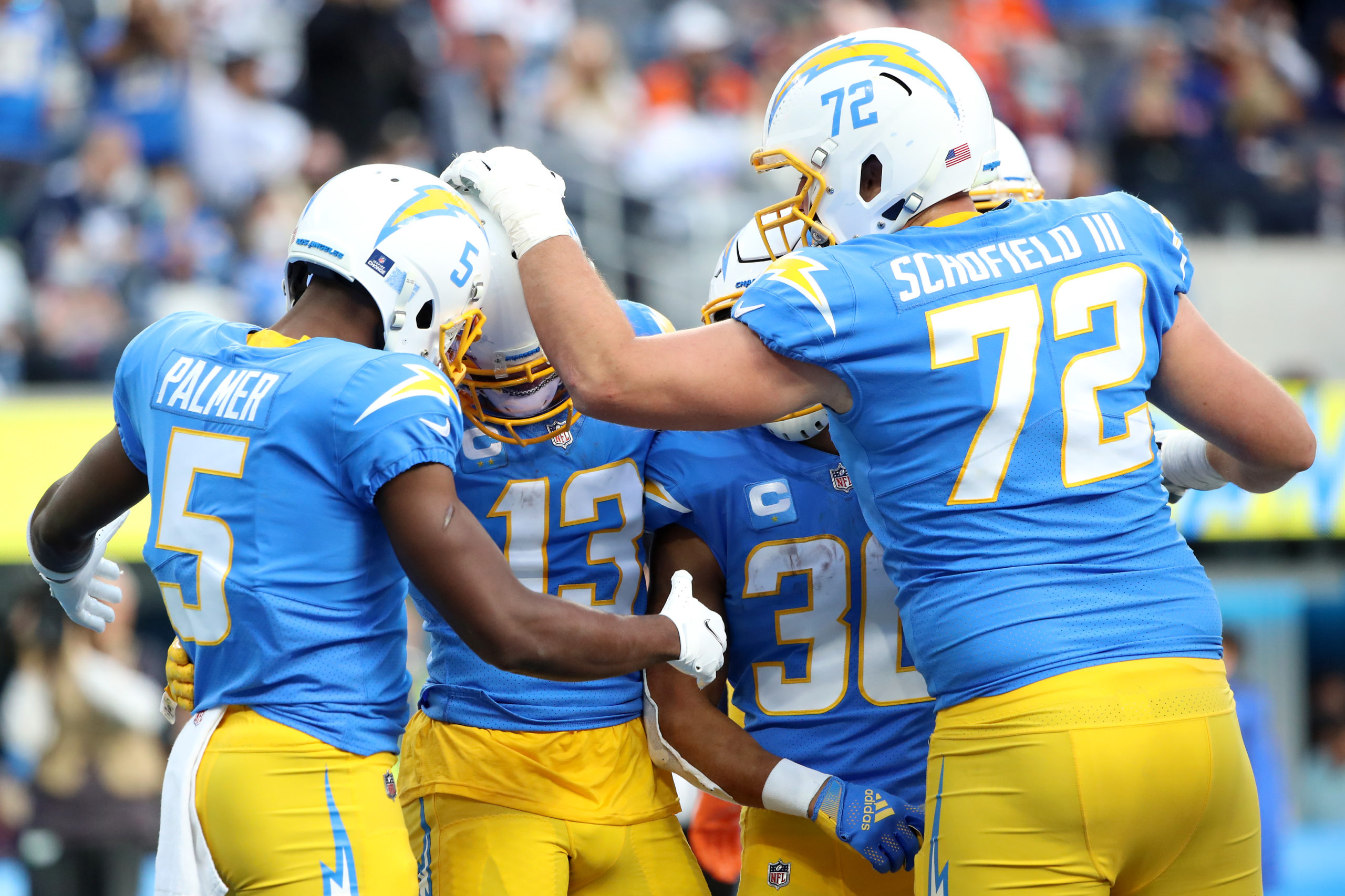 INGLEWOOD, CALIFORNIA - JANUARY 02: Keenan Allen #13 of the Los Angeles Chargers celebrates his touchdown with teammates Josh Palmer #5, Austin Ekeler #30 and Michael Schofield #72 during the second quarter against the Denver Broncos at SoFi Stadium on January 02, 2022 in Inglewood, California. (Photo by Katelyn Mulcahy/Getty Images)