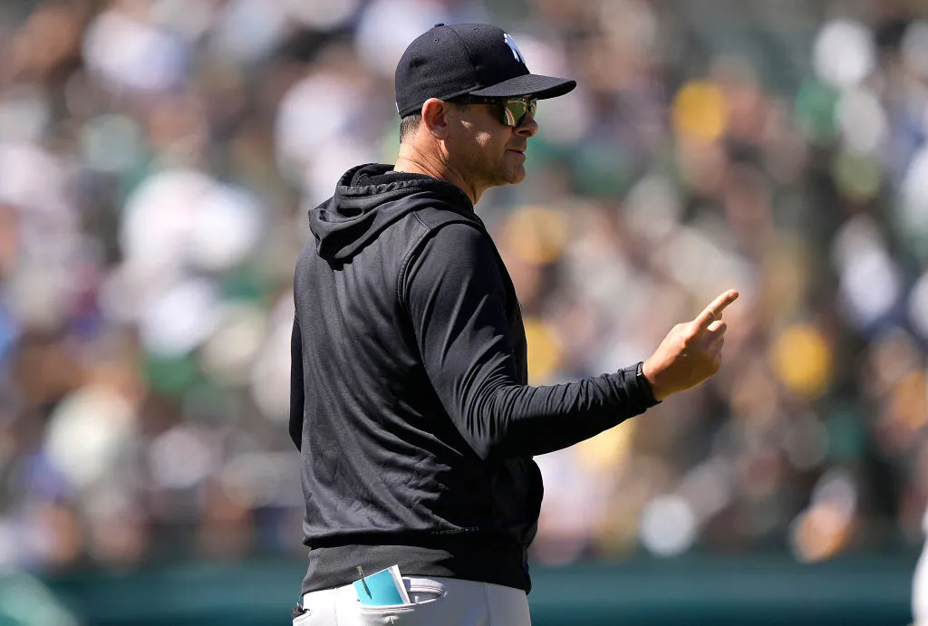 OAKLAND, CALIFORNIA - AUGUST 28: Manager Aaron Boone #17 of the New York Yankees signals the bull pen to make a pitching change against the Oakland Athletics in the bottom of the six inning at RingCentral Coliseum on August 28, 2022 in Oakland, California. (Photo by Thearon W. Henderson/Getty Images)