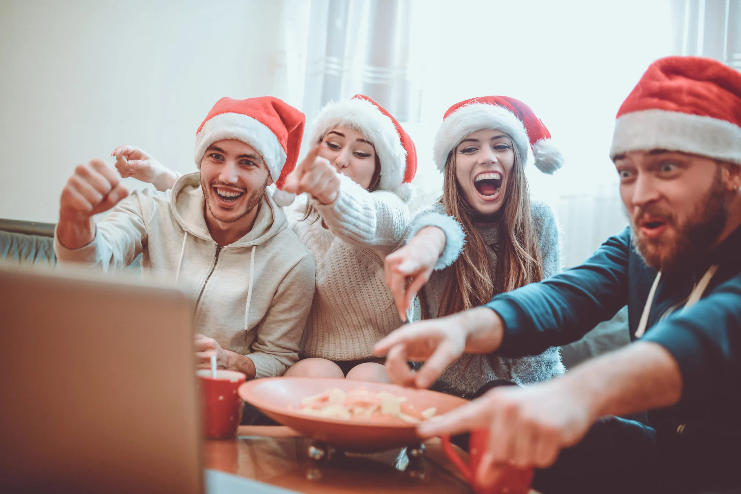 Group of Excited Friend Drink Hot Drink and Watch Interesting Football Game for The Holidays