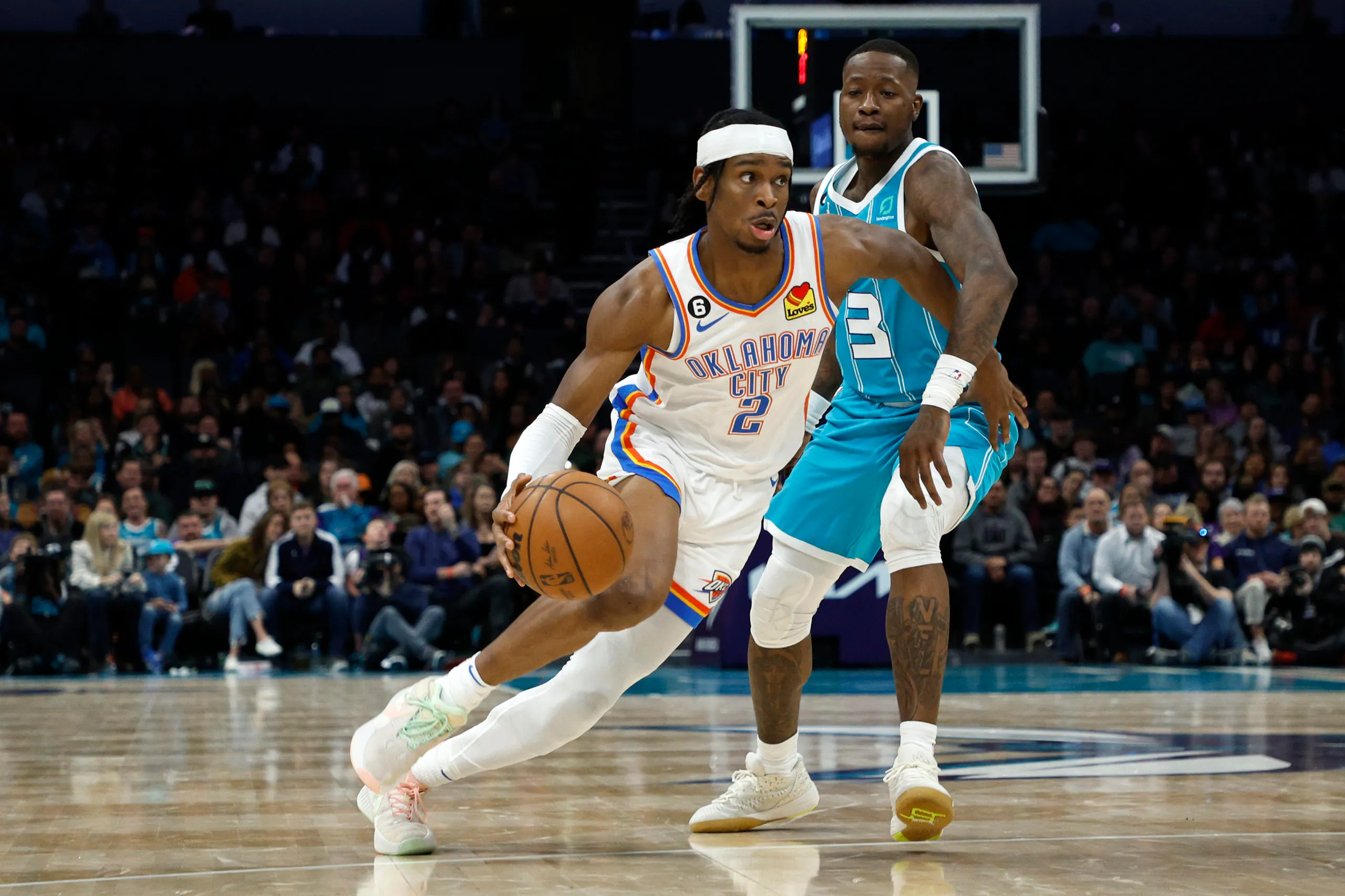 CHARLOTTE, NORTH CAROLINA - DECEMBER 29: Shai Gilgeous-Alexander #2 of the Oklahoma City Thunder drives to the basket against Terry Rozier #3 of the Charlotte Hornets during the second half of the game at Spectrum Center on December 29, 2022 in Charlotte, North Carolina. NOTE TO USER: User expressly acknowledges and agrees that, by downloading and or using this photograph, User is consenting to the terms and conditions of the Getty Images License Agreement. (Photo by Jared C. Tilton/Getty Images)