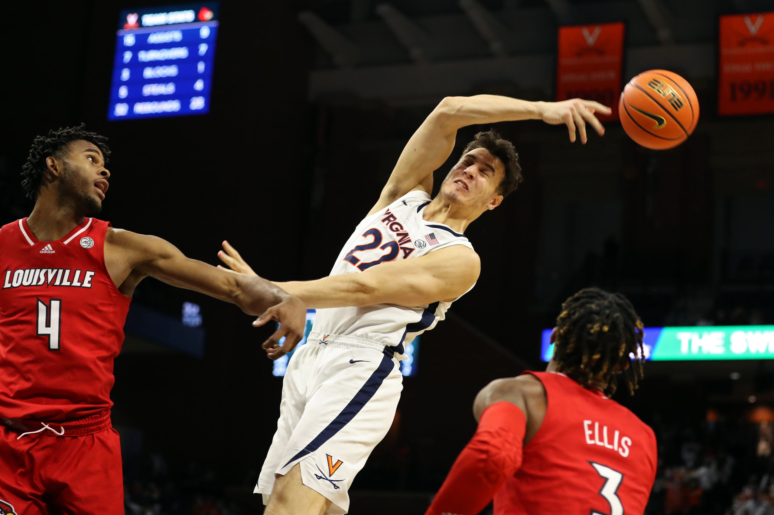 CHARLOTTESVILLE, VA - JANUARY 24: Francisco Caffaro #22 of the Virginia Cavaliers swipes a rebound away from Roosevelt Wheeler #4 of the Louisville Cardinals in the second half during a game at John Paul Jones Arena on January 24, 2022 in Charlottesville, Virginia. (Photo by Ryan M. Kelly/Getty Images)