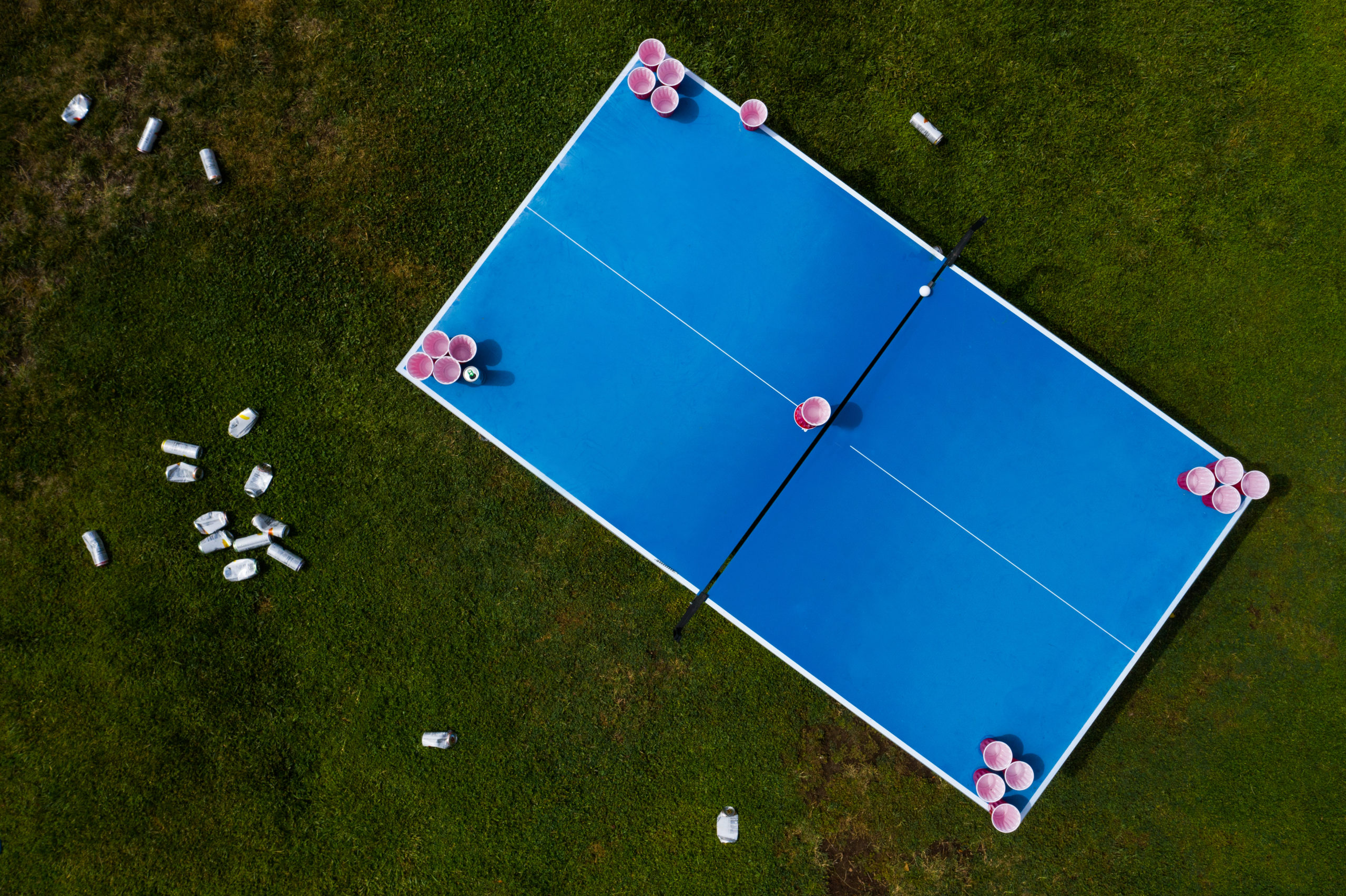 Drone view of the morning after a beer pong party held in a residential backyard