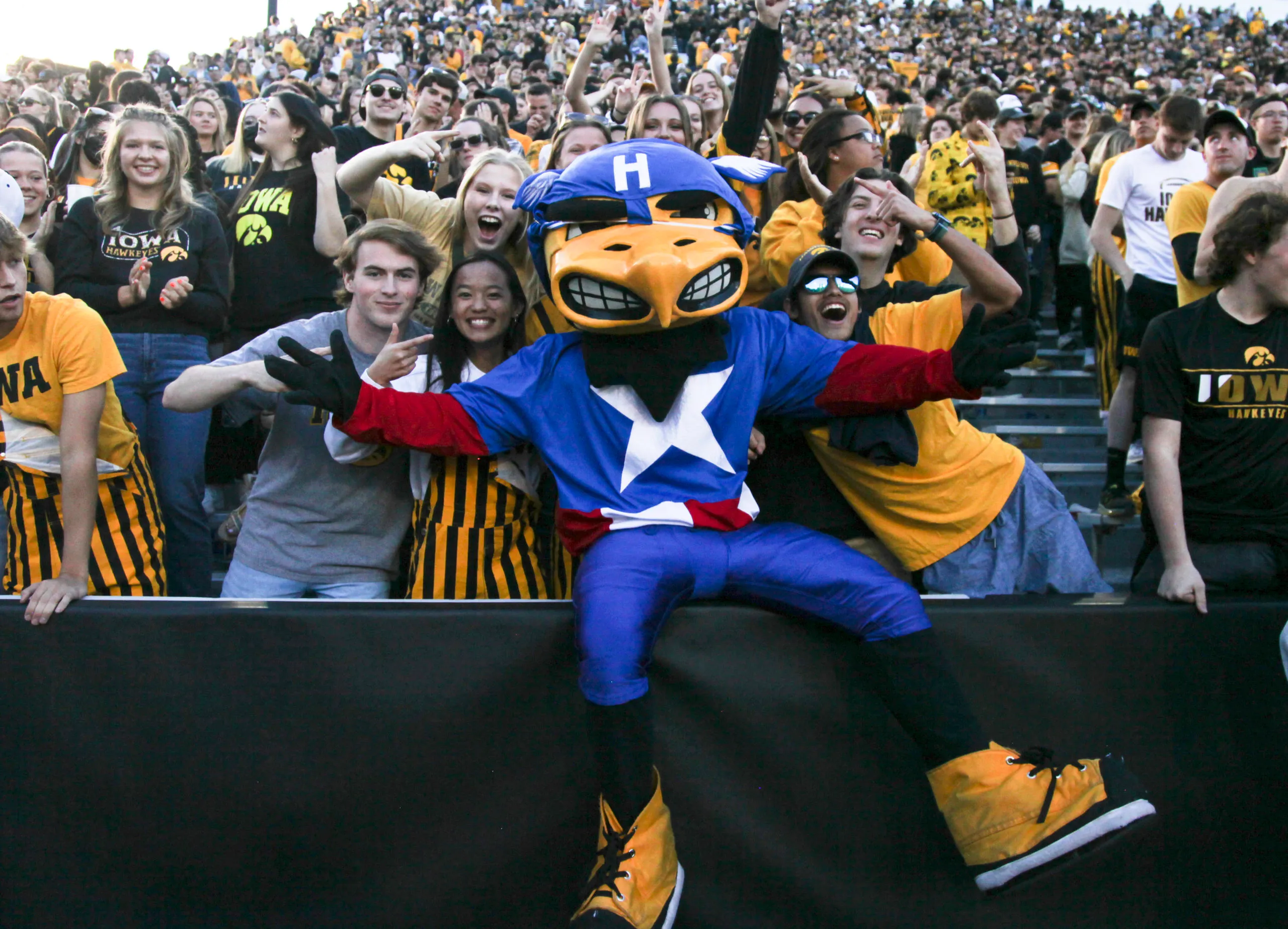 IOWA CITY, IOWA- OCTOBER 29:  Fans cheer in the student section with the mascot Herky the Hawk  during the match-up between the Northwestern Wildcats and the Iowa Hawkeyes at Kinnick Stadium, on October 29, 2022 in Iowa City, Iowa.  (Photo by Matthew Holst/Getty Images)