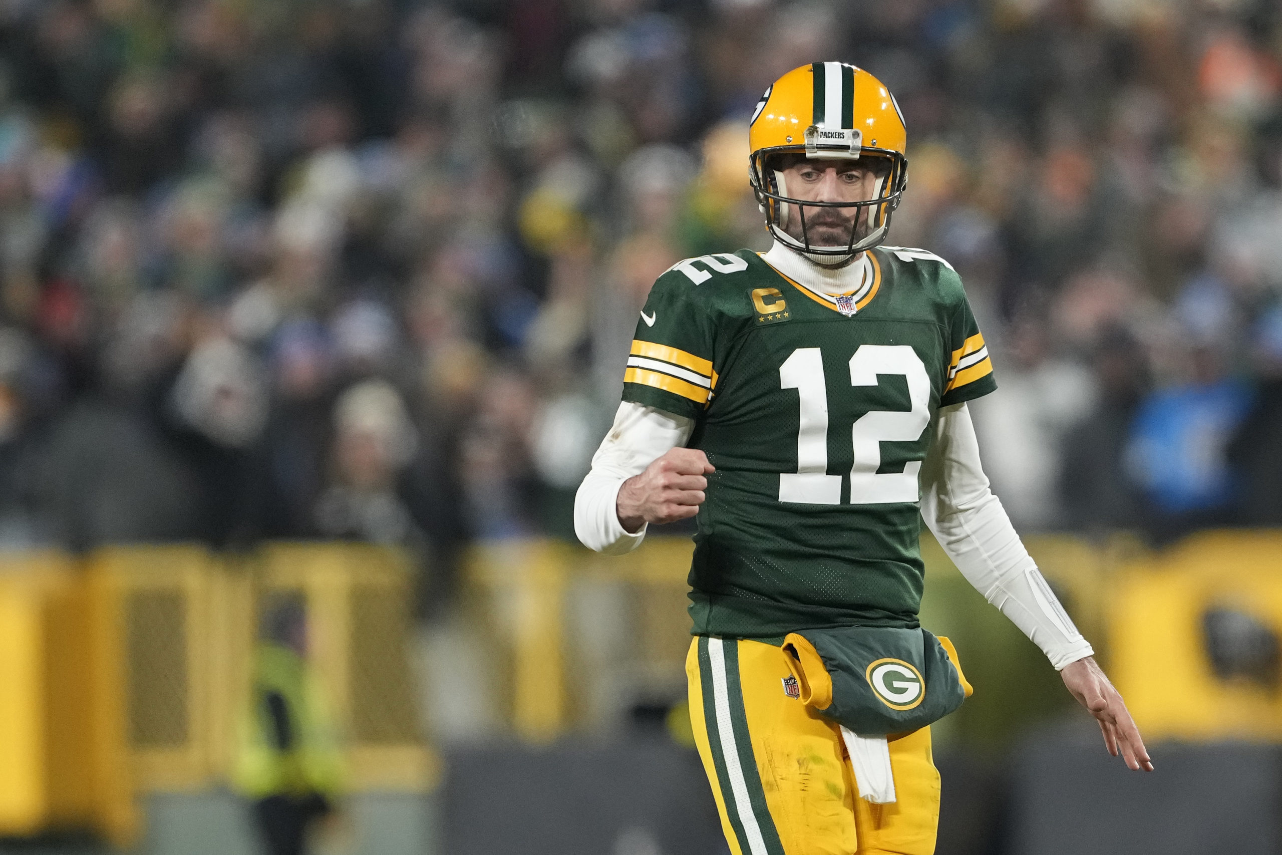GREEN BAY, WISCONSIN - JANUARY 08: Aaron Rodgers #12 of the Green Bay Packers celebrates against the Detroit Lions in the second half at Lambeau Field on January 08, 2023 in Green Bay, Wisconsin. (Photo by Patrick McDermott/Getty Images)