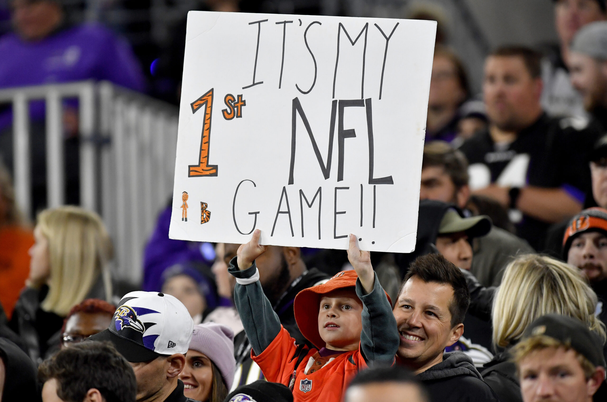 BALTIMORE, MD - OCTOBER 09: A young boy / child / fan holds up a sign that reads Its My First NFL Game!! during the Cincinnati Bengals versus Baltimore Ravens NFL game at M&T Bank Stadium on October 9, 2022 in Baltimore, MD. (Photo by Randy Litzinger/Icon Sportswire via Getty Images)