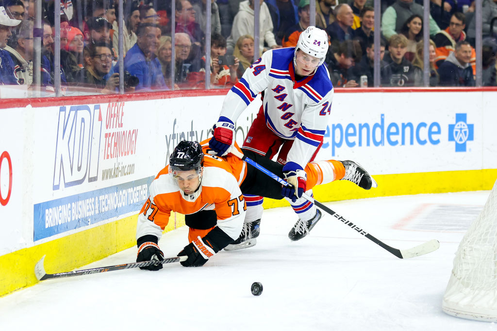PHILADELPHIA, PENNSYLVANIA - MARCH 01: Tony DeAngelo #77 of the Philadelphia Flyers and Kaapo Kakko #24 of the New York Rangers challenge for the puck during the third period at Wells Fargo Center on March 01, 2023 in Philadelphia, Pennsylvania. (Photo by Tim Nwachukwu/Getty Images)