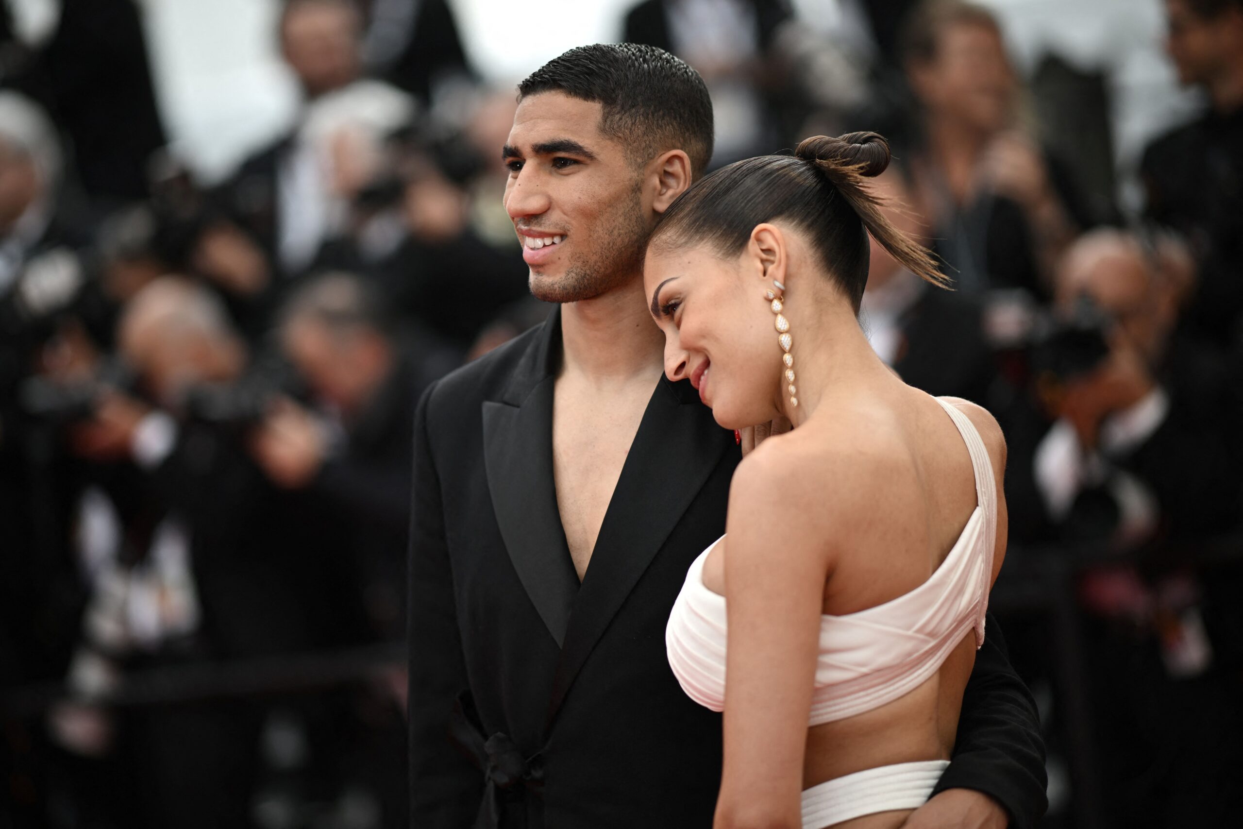 Moroccan defender Achraf Hakimi (L) and his wife Hiba Abouk arrive for the screening of the film "The Innocent (L'Innocent)" during the 75th edition of the Cannes Film Festival in Cannes, southern France, on May 24, 2022. (Photo by LOIC VENANCE / AFP) (Photo by LOIC VENANCE/AFP via Getty Images)