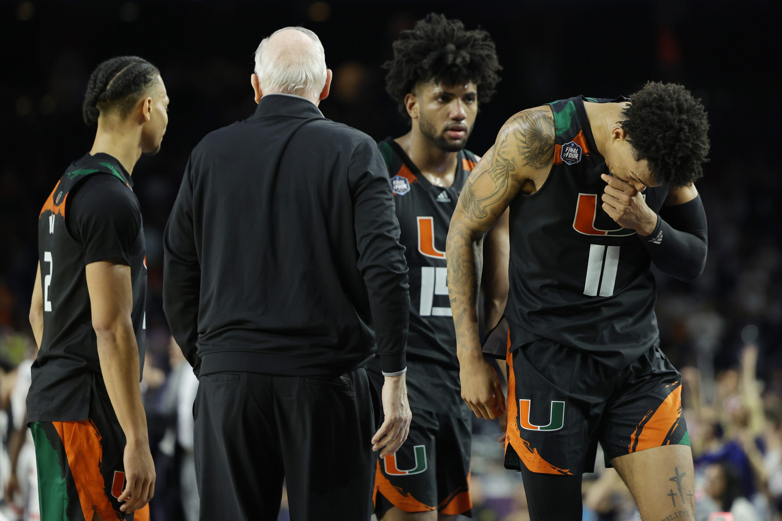 HOUSTON, TEXAS - APRIL 01: Jordan Miller #11 of the Miami Hurricanes and teammates react after losing to the Connecticut Huskies 72-59 during the NCAA Men's Basketball Tournament Final Four semifinal game at NRG Stadium on April 01, 2023 in Houston, Texas. (Photo by Carmen Mandato/Getty Images)