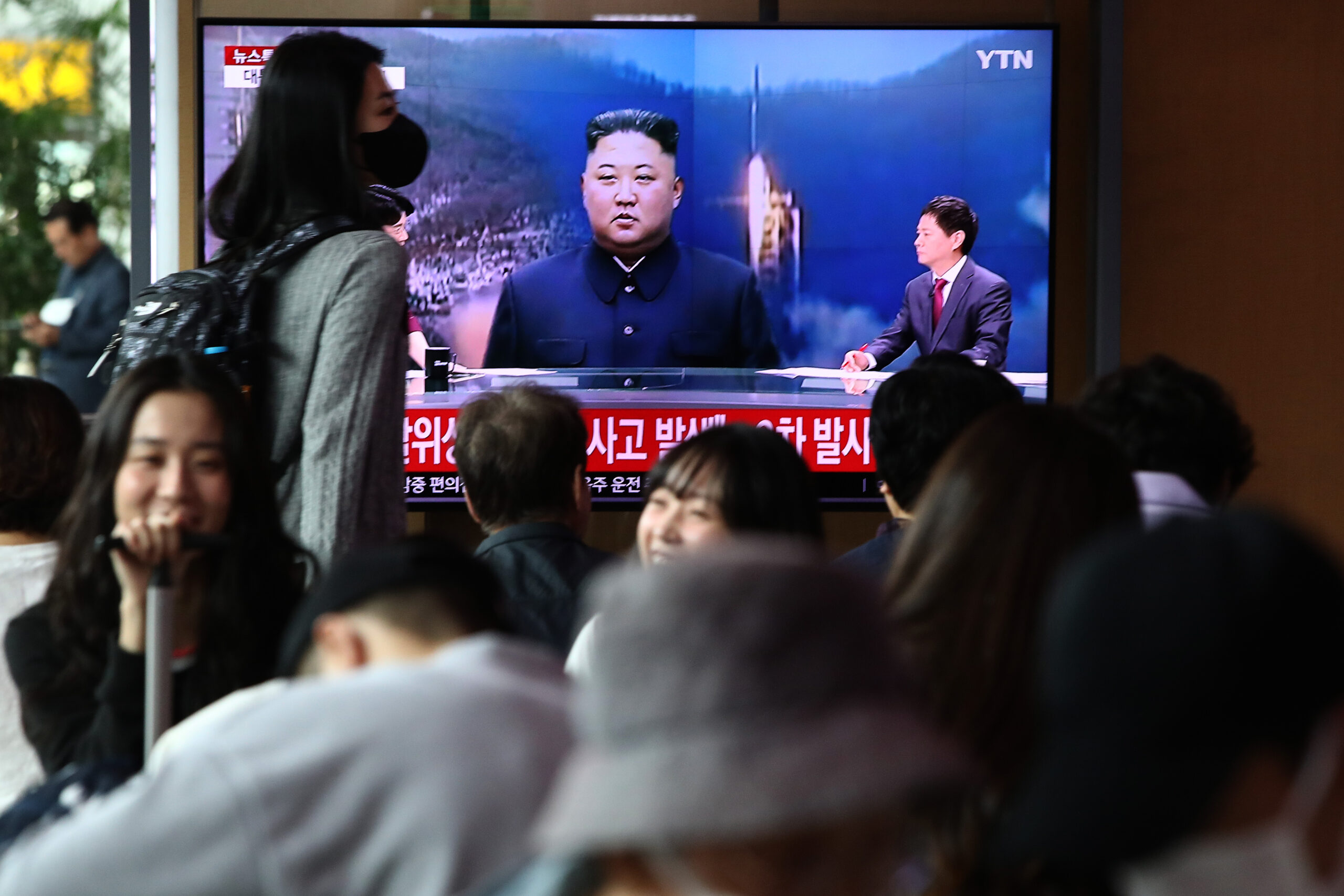 SEOUL, SOUTH KOREA - MAY 31: People watch a television broadcast showing a file image of a North Korean leader Kim Jong-Un at the Seoul Railway Station on May 31, 2023 in Seoul, South Korea. North Korea fired what it claims to be a "space launch vehicle" southward Wednesday, but it fell into the Yellow Sea after an "abnormal" flight, the South Korean military said, in a botched launch that defied international criticism and warnings. (Photo by Chung Sung-Jun/Getty Images)