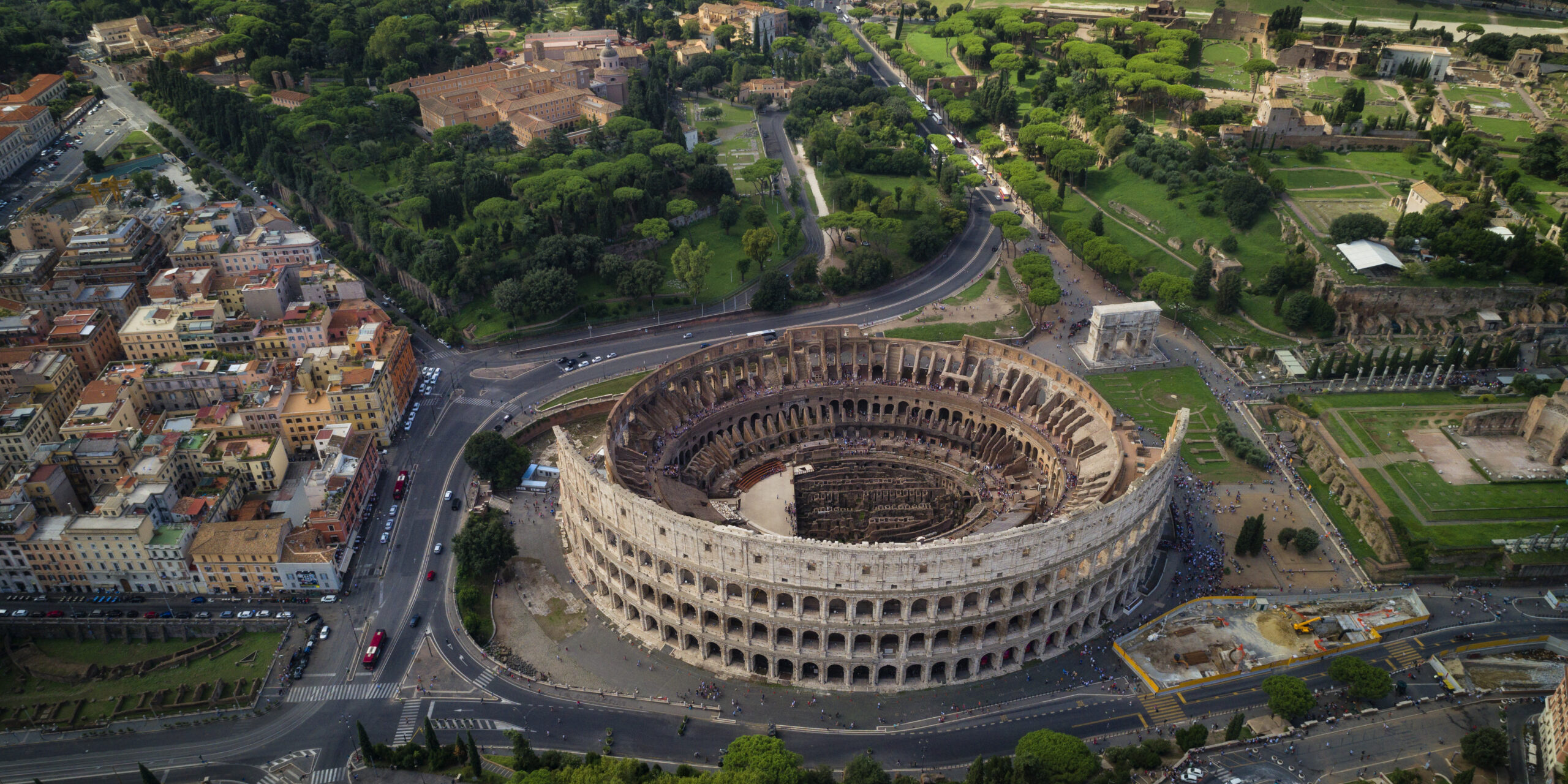 This is an aerial view of the Colosseum in the city of Rome, Italy