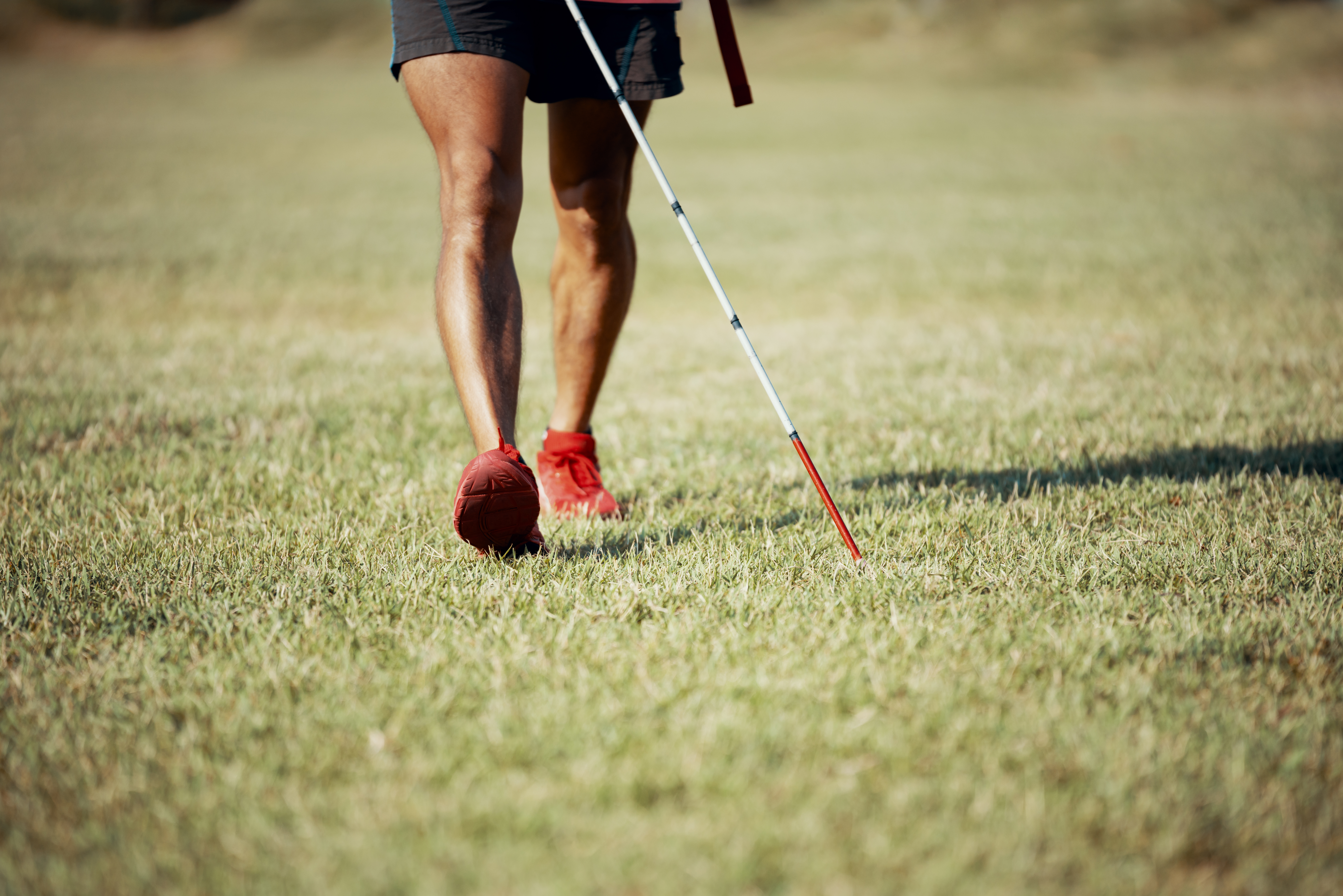 Blind marathon athlete walking with his white cane before competing
