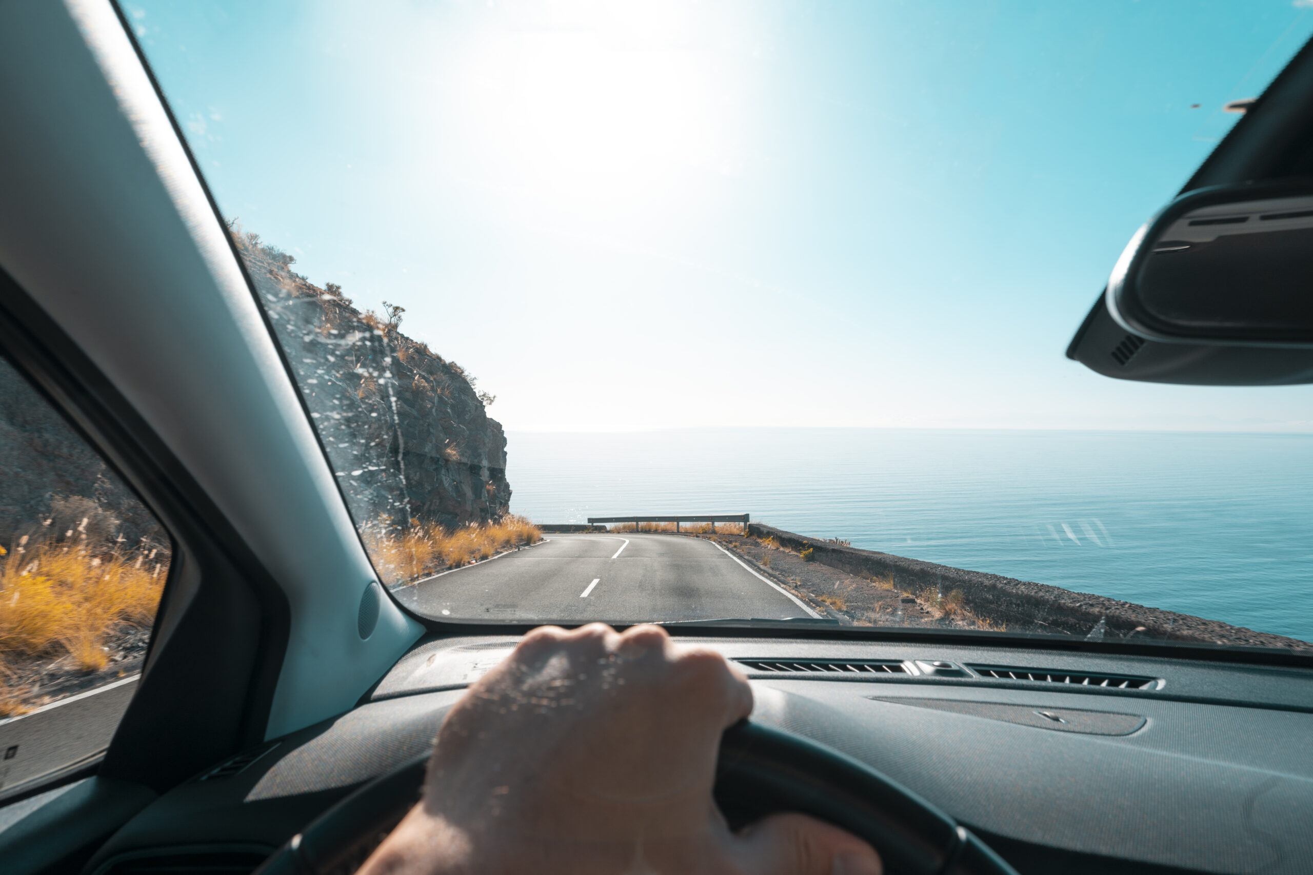 Personal perspective of person driving along the coast