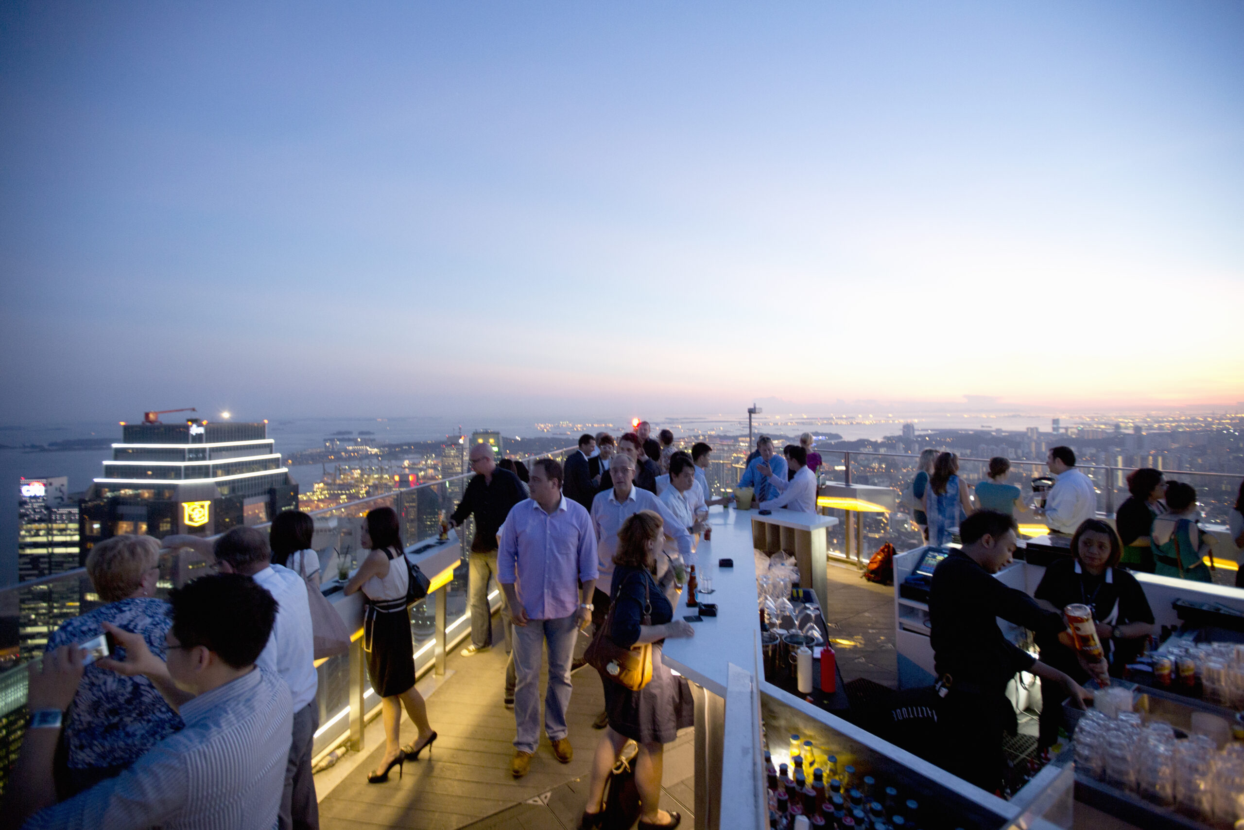 People enjoying sunset from rooftop bar