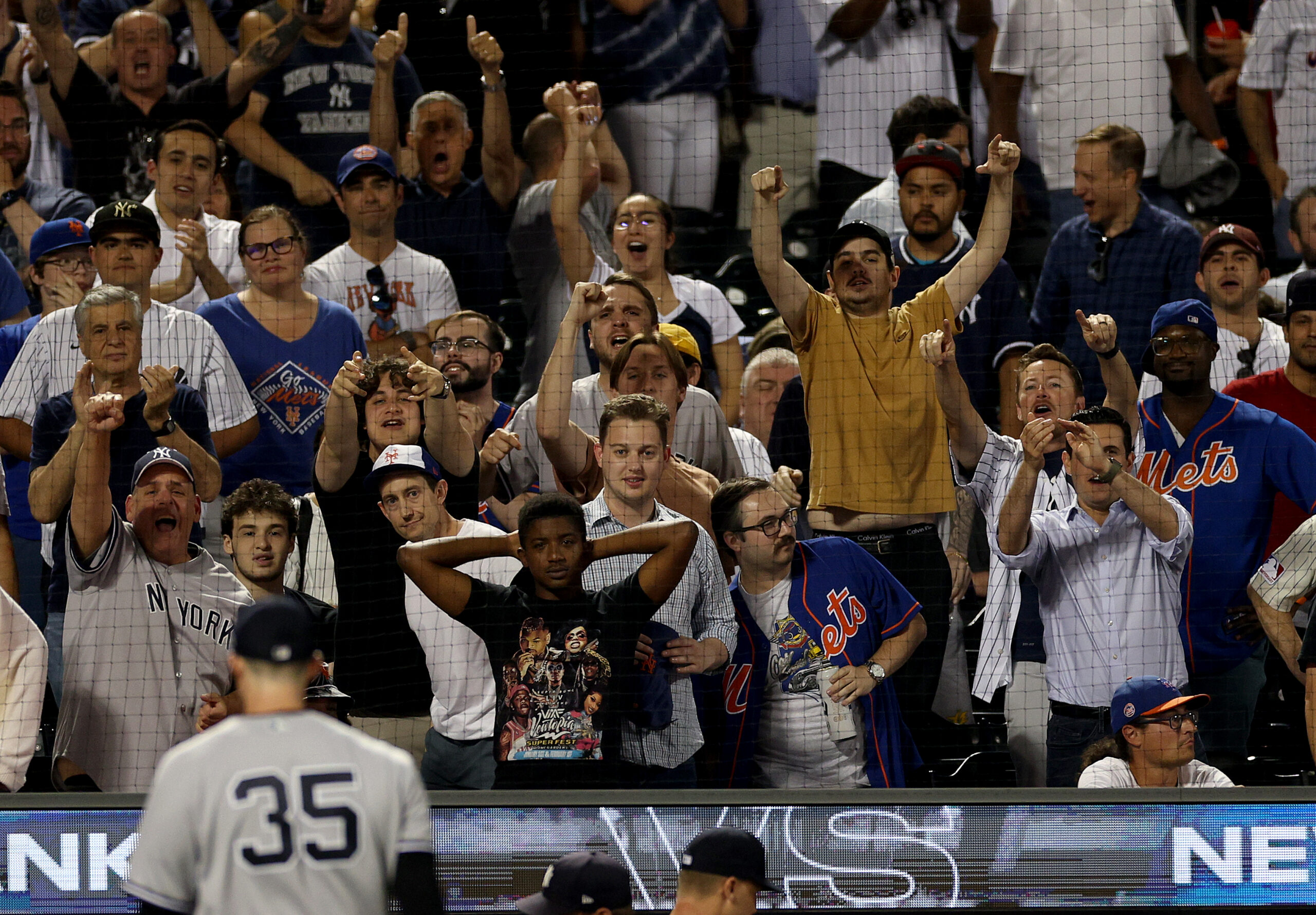 NEW YORK, NEW YORK - JUNE 13:  New York Yankees fans celebrate after Clay Holmes #35 of the New York Yankees struck out Starling Marte of the New York Mets with the bases loaded in the eighth inning at Citi Field on June 13, 2023 in the Flushing neighborhood of the Queens borough of New York City. The New York Yankees defeated the New York Mets 7-6. (Photo by Elsa/Getty Images)