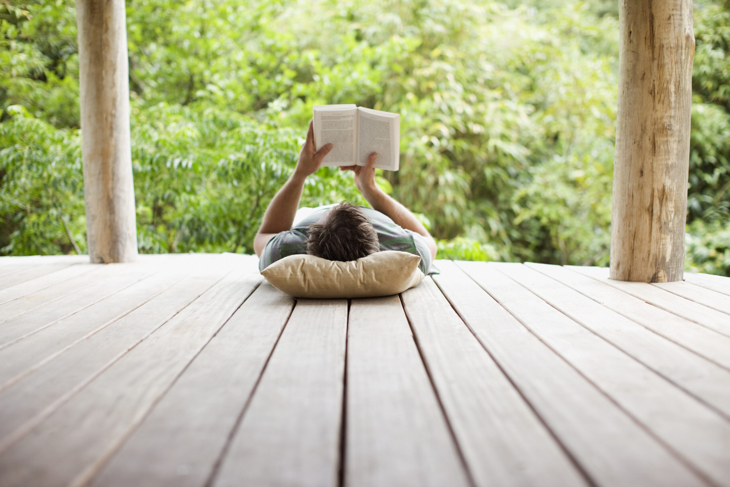 Man reading on porch in remote area