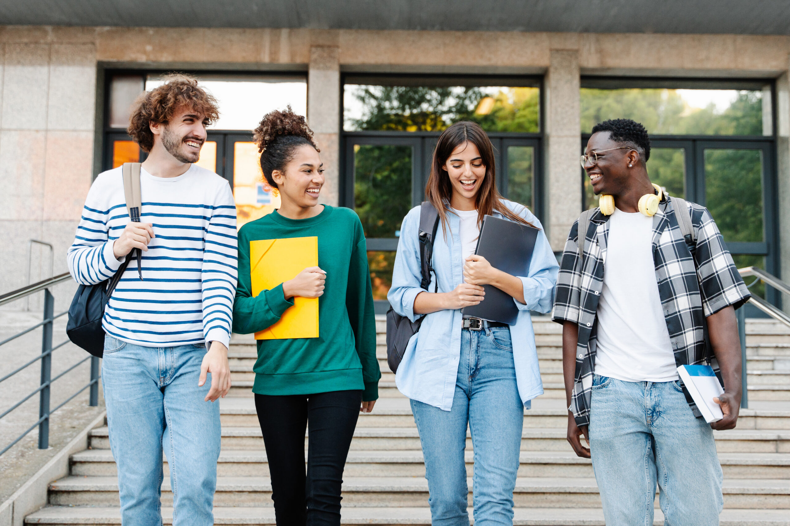 College majors. Happy students. Happy students photo. Friends in Walking. Students Walking and talking back view.