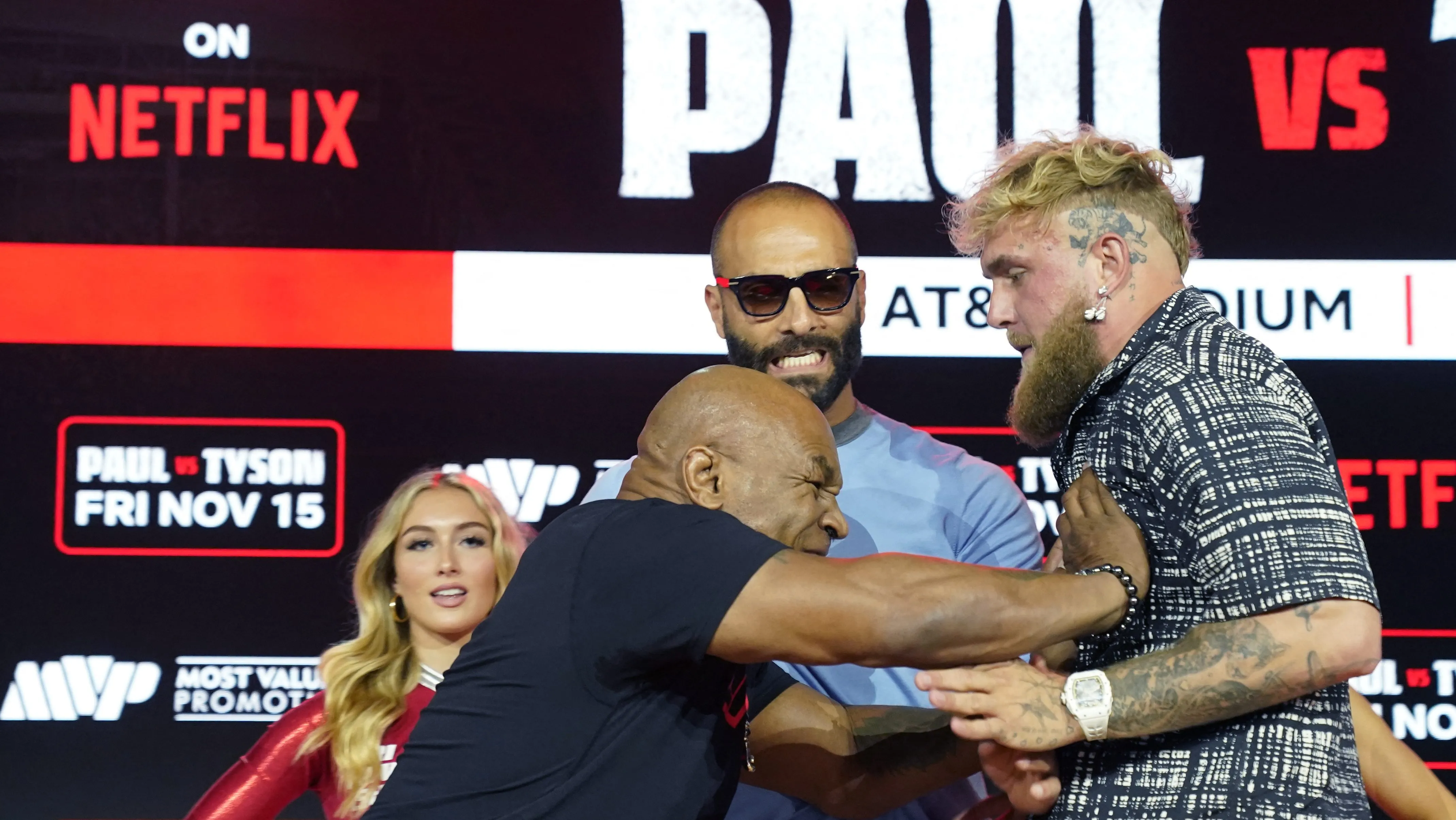 (L-R) Former US heavyweight boxing champion Mike Tyson and US YouTuber and boxer Jake Paul face off during a press conference at Fanatics Fest NYC on August 18, 2024, in New York City. The heavyweight match has been rescheduled for November 15, 2024, and will take place in Arlington, Texas. (Photo by TIMOTHY A. CLARY / AFP) (Photo by TIMOTHY A. CLARY/AFP via Getty Images)